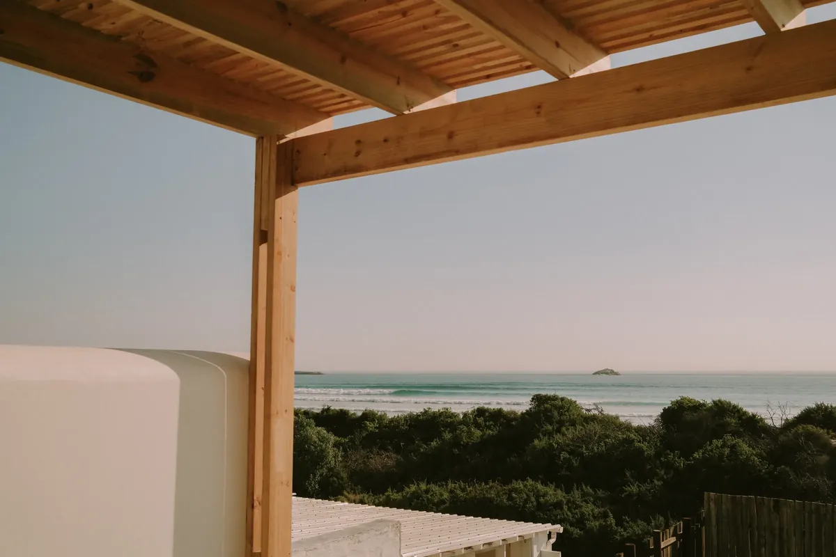 The Atlantic and a small island seen from beneath a timber pergola