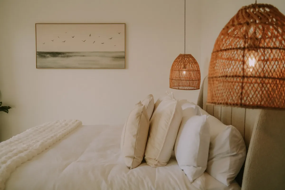 White linen and woven rattan lights in a guest bedroom